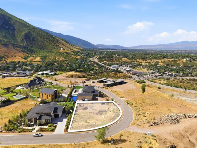 Sloped lot with a curved road frontage, surrounded by established residential properties