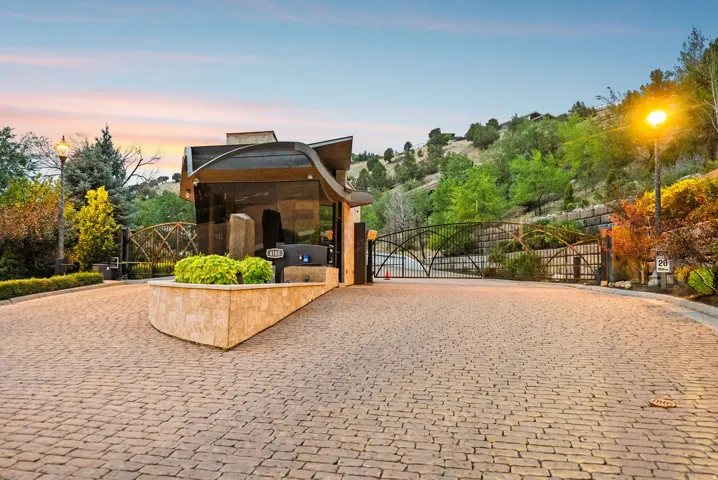 Cobblestone paver driveway with a curved stone planter