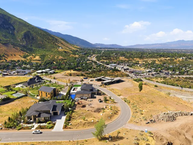 Mountain landscape featuring residential developments and paved roadways