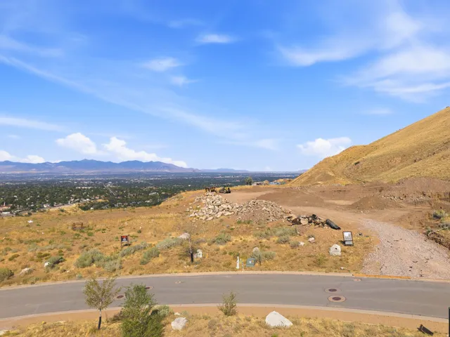 Expansive mountain terrain with a distant city below