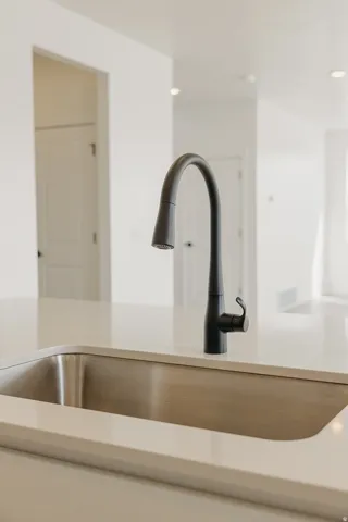 Stainless steel undermount sink with a matte black gooseneck faucet