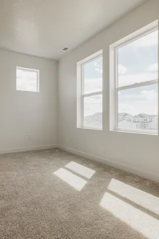 Bright interior with a textured ceiling and light-colored carpet flooring