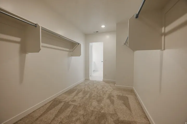 Spacious closet with integrated shelving and hanging rods