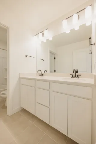 Dual vanity with white cabinetry and integrated sinks