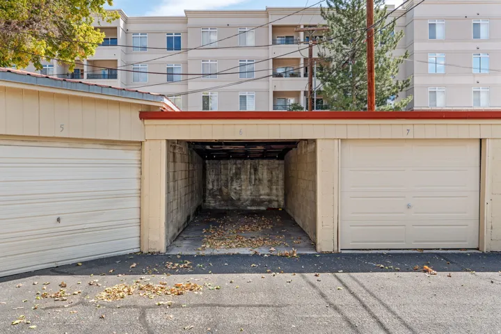 Individual garage stalls featuring roll-up doors and concrete block construction