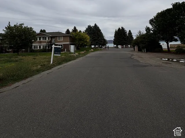 Road driving up to lot, with lake views across the street from the marina