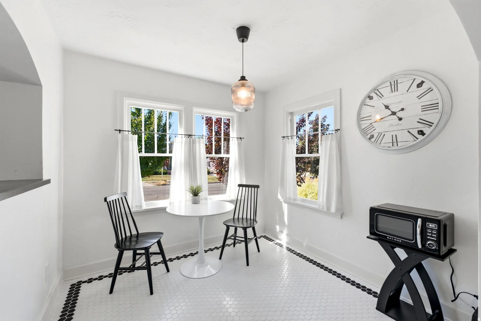 White hexagonal tile flooring with a black border
