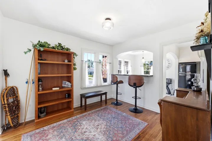 Hardwood flooring, arched pass-through, built-in breakfast bar, and multiple windows