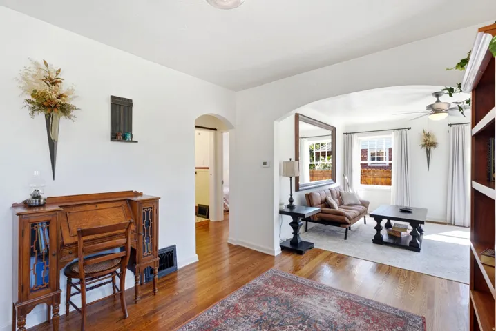 Hardwood-finish flooring throughout, arched doorway, recessed lighting, and built-in shelving