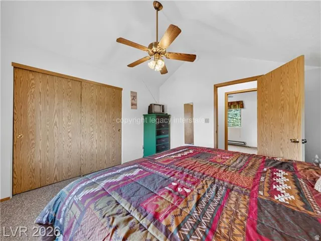 Vaulted ceiling featuring a ceiling fan with integrated lighting