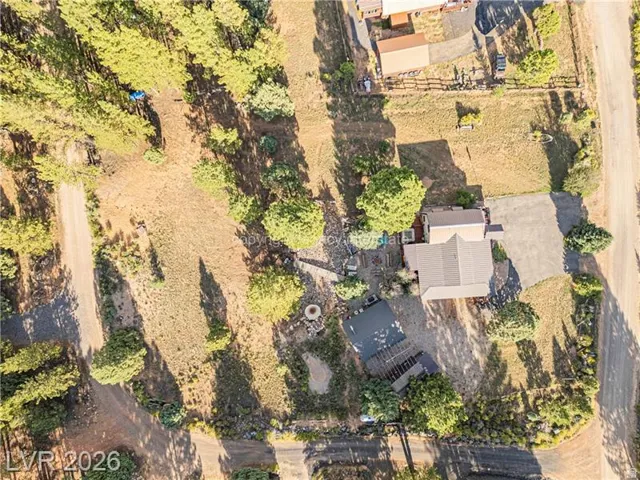 Expansive property featuring mature trees and a detached structure
