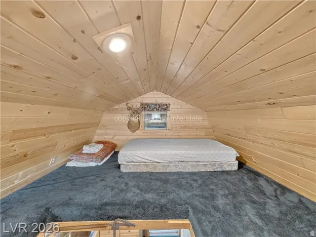 Loft area featuring vaulted wood-paneled ceilings, recessed lighting, a window, and gray carpeting