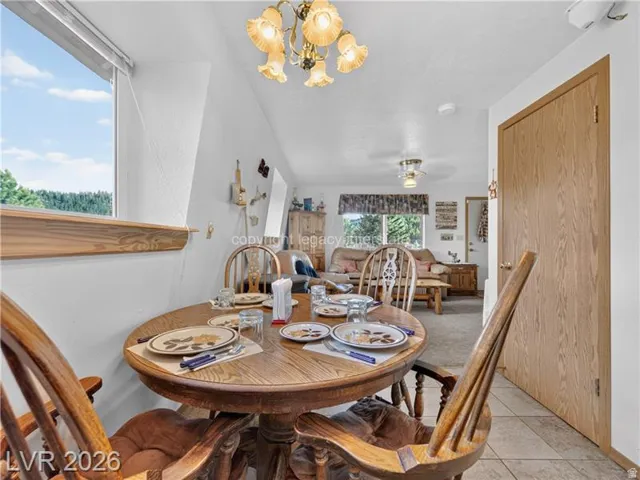 Wood-finish flooring, wood-finish interior door, recessed lighting, and a prominent window