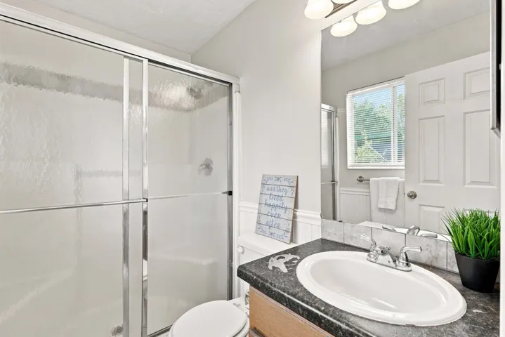 Shower with sliding glass enclosure