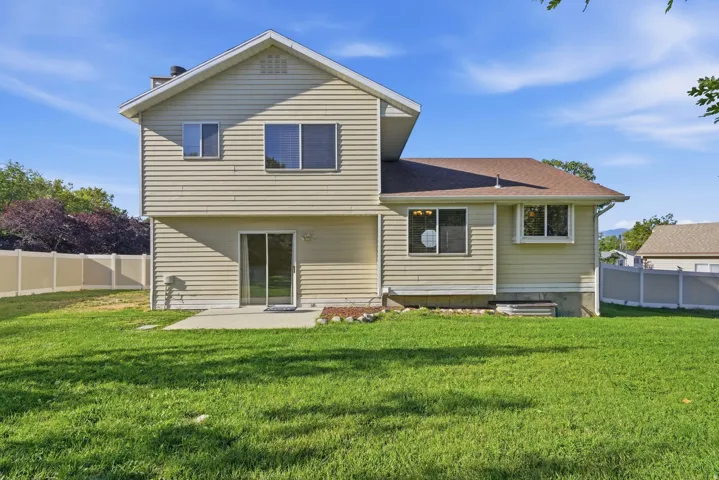 Two-story residence with horizontal siding, a brown shingle roof, and multiple windows