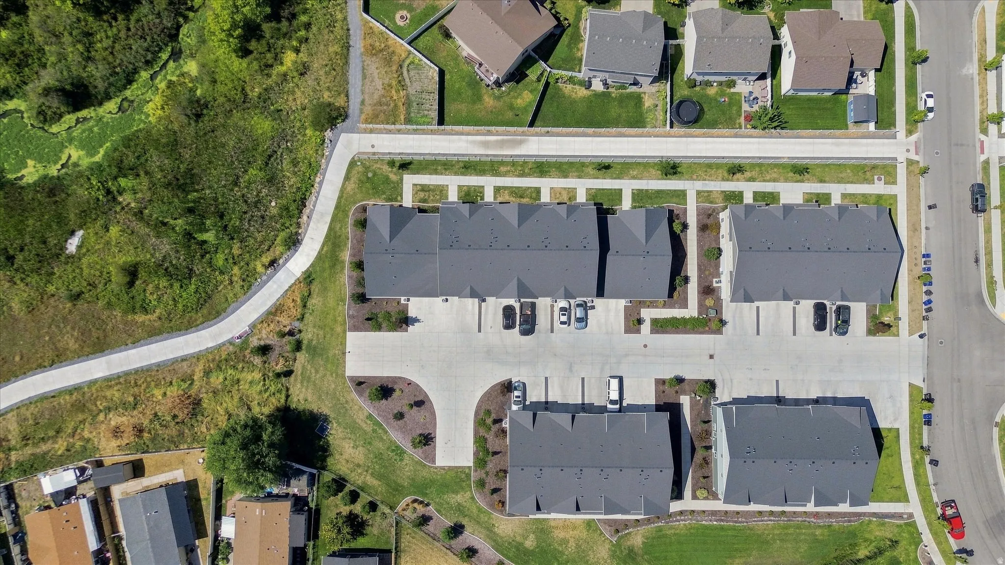 Community featuring townhome-style residences, dedicated parking areas, paved walking paths, and landscaped common grounds