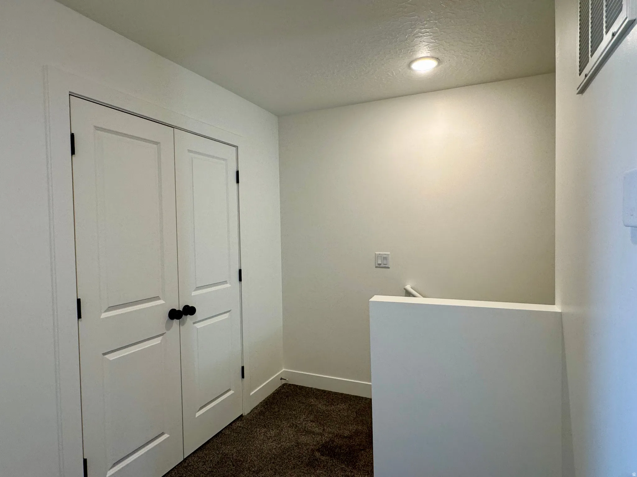 Storage closet at the top of the stairway