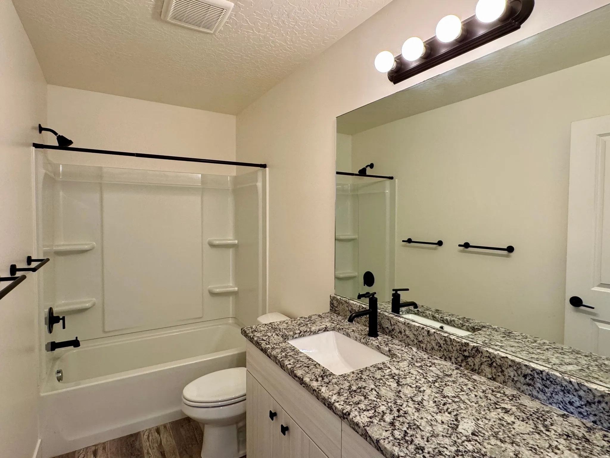 Vanity with granite countertop and undermount sink