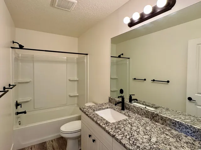 Vanity with granite countertop and undermount sink