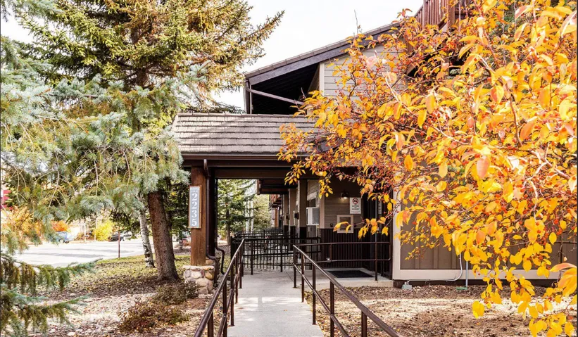 Covered entry with shingle roof and wood columns