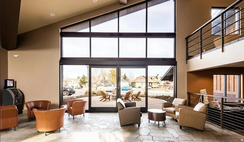 Soaring two-story atrium with expansive floor-to-ceiling windows framing natural light throughout