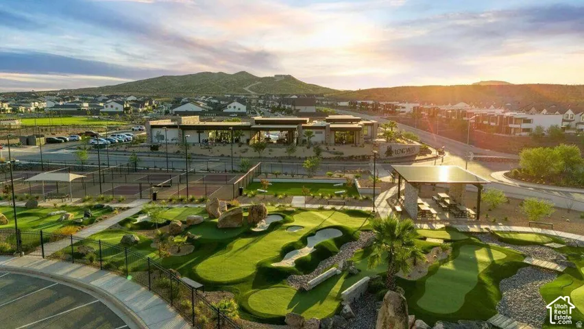 Community amenities featuring a miniature golf course, tennis courts, covered outdoor seating areas, and a modern clubhouse