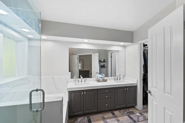 Dual vanity with undermount sinks, a substantial mirror, and recessed lighting