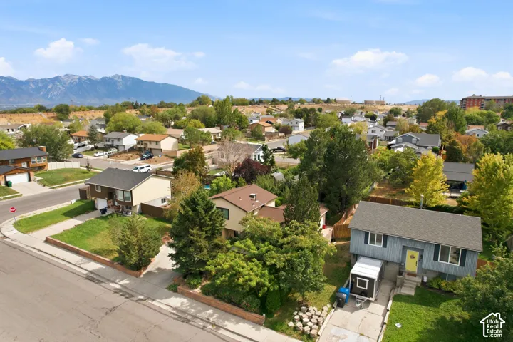 Summit Park, located next to the water tanks. Residential street with established homes, mature trees, and a distant mountain backdrop