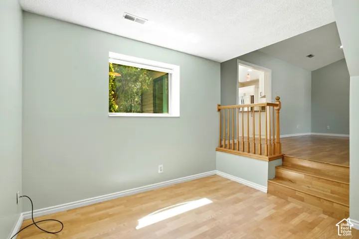 Office/Flex space. Recessed window, wood-finish flooring, two-tone wall paint, wood railing, and built-in steps