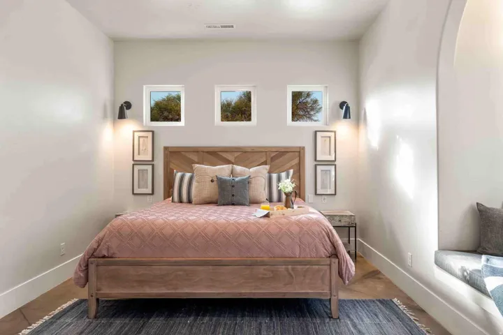 Neutral wall finishes, recessed window openings, built-in window seat, and sconce lighting