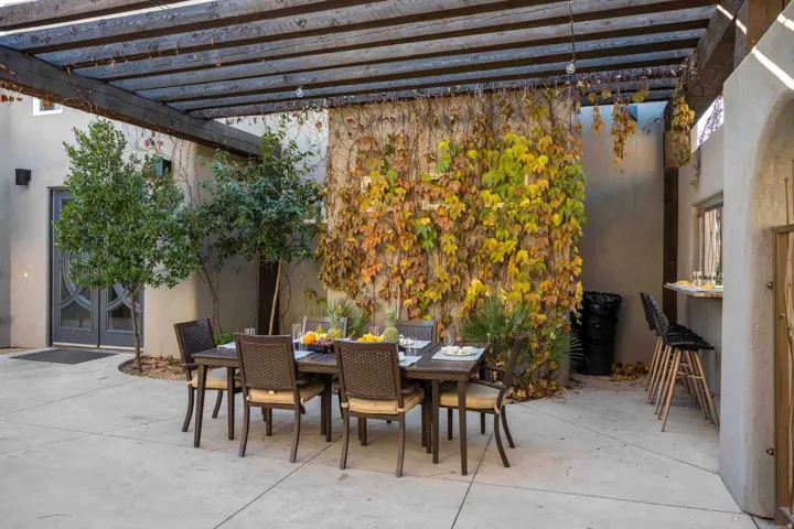 Exposed beam pergola structure over a concrete patio