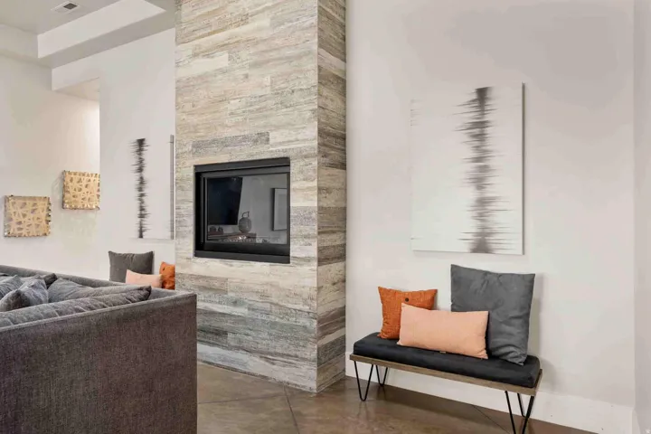 Floor-to-ceiling fireplace with a multi-tone tile surround and a black-framed insert