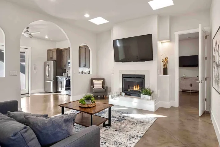 Living area featuring a fireplace with a mantel, recessed lighting, and skylights