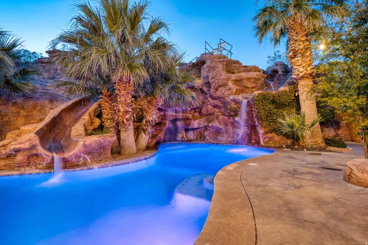 Custom rock grotto with a waterfall and integrated slide
