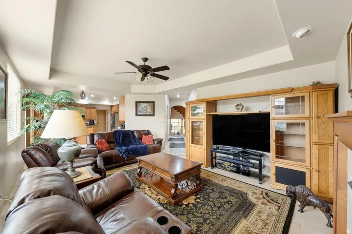 Spacious living area featuring a coffered ceiling, recessed lighting, and a ceiling fan