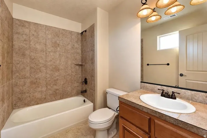 Tiled bath and shower combination with dark bronze fixtures