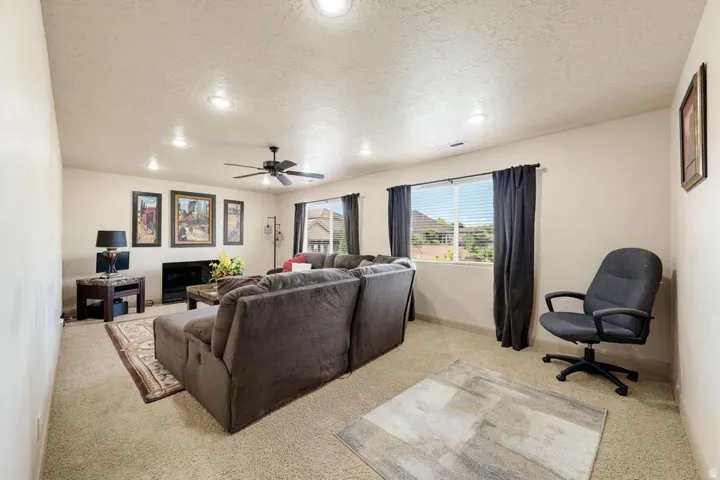 Recessed ceiling lighting, ceiling fan, carpeted flooring, and two windows