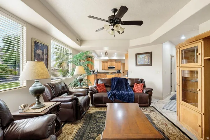 Recessed lighting, ceiling fan, and multiple windows with blinds