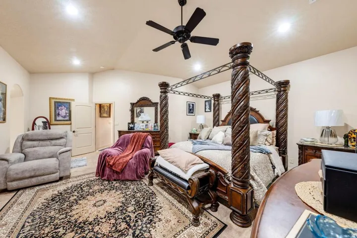 Vaulted ceilings, recessed lighting, ceiling fan, and arched doorway
