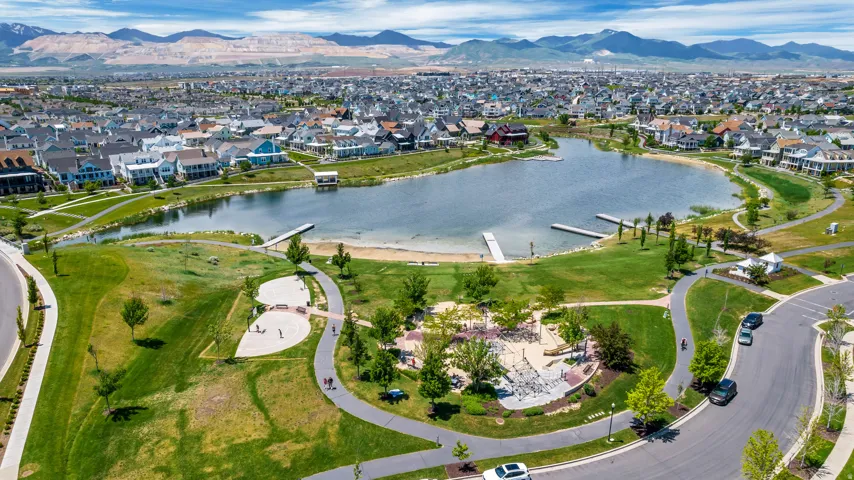 Lakeside community with extensive green spaces, paved walking paths, and a public lake access with docks