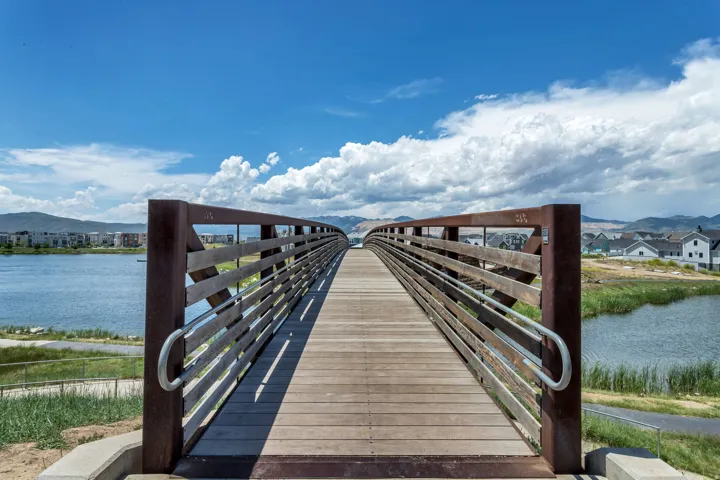Pedestrian bridge with wood-finish decking and metal railings