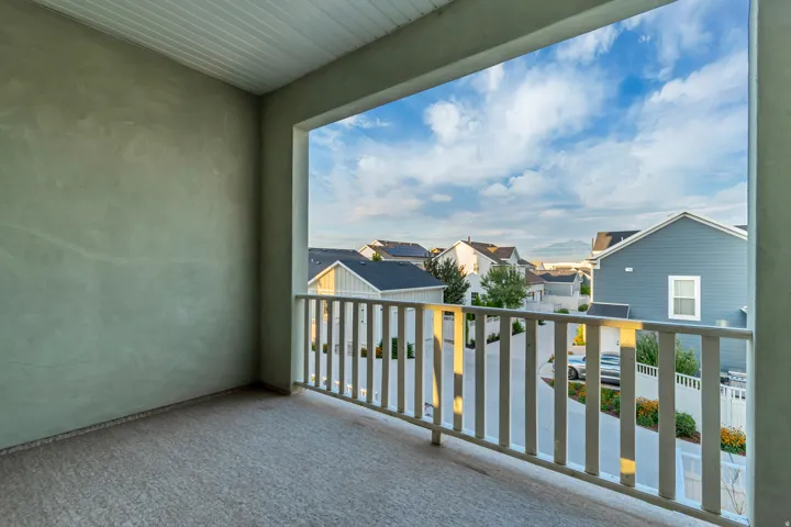 Balcony featuring a durable railing and textured wall finish