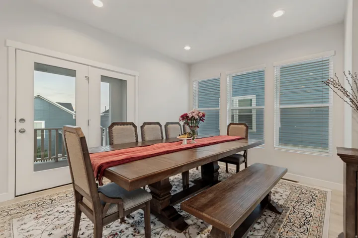 Recessed ceiling lighting, multiple windows, French doors, and light wood-finish flooring