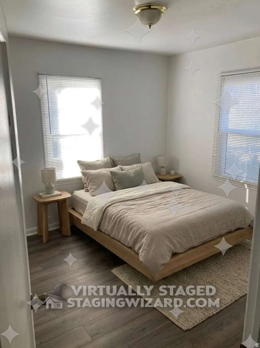 Wood-finish flooring with white walls and a ceiling-mounted light fixture