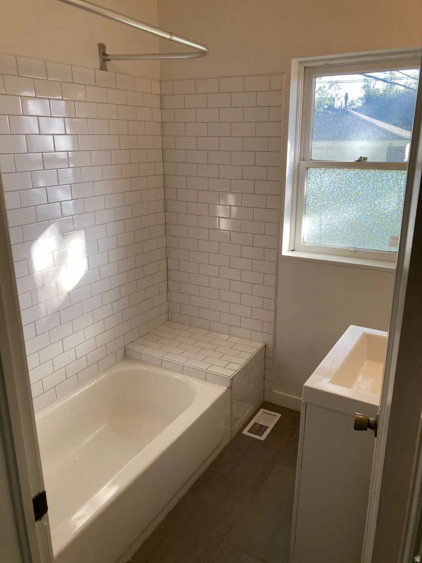White subway tile shower surround with integrated tiled bench