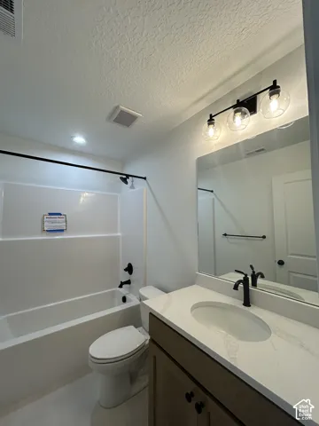 Modern vanity with a light-toned countertop, oval undermount sink, and matte black faucet