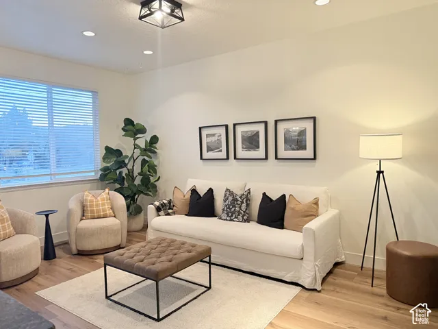 Wood-finish flooring, recessed lighting, and a window with blinds