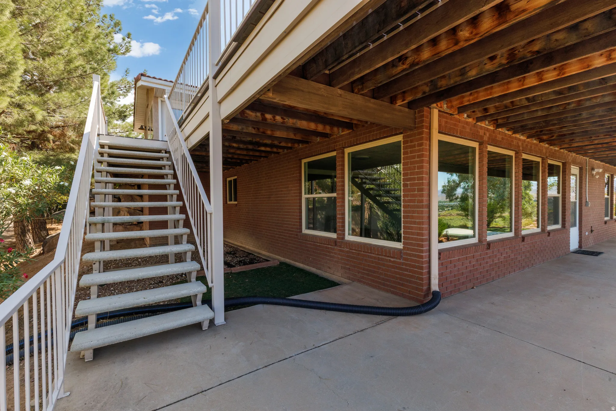 Stairs leading from level 1 deck to lower level patio.