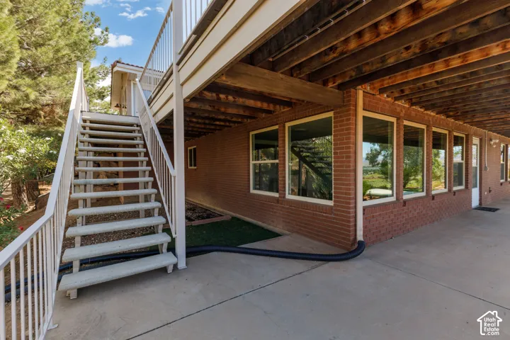 Stairs leading from level 1 deck to lower level patio.