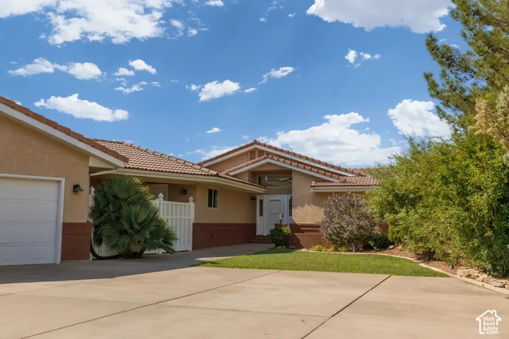 Stucco exterior with brick detailing and a tile roof